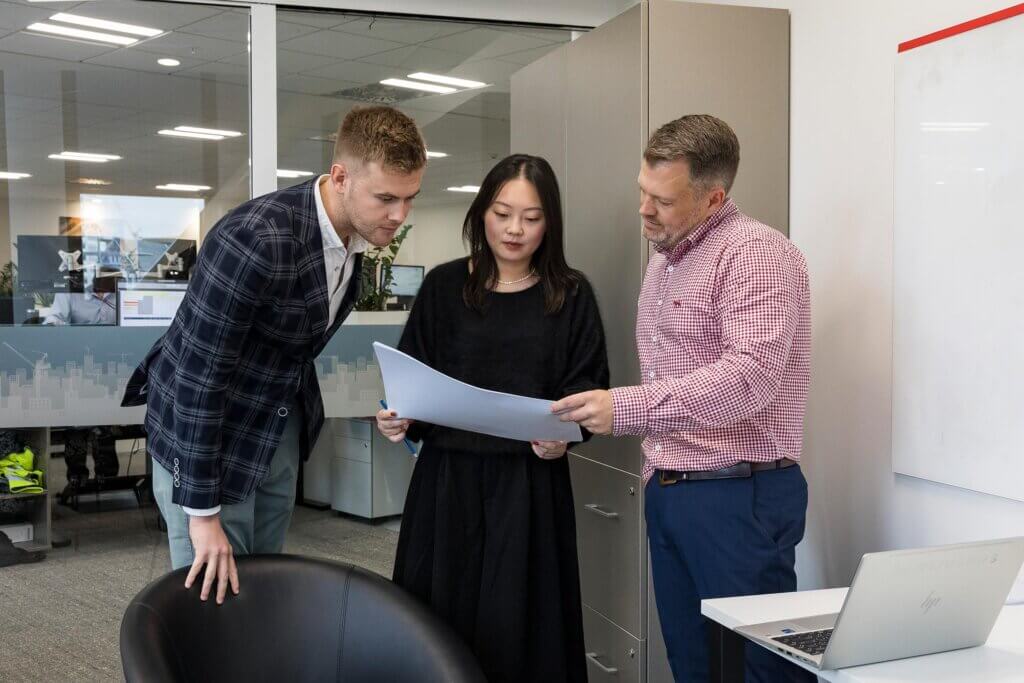 peer-review Three staff members peer reviewing a document