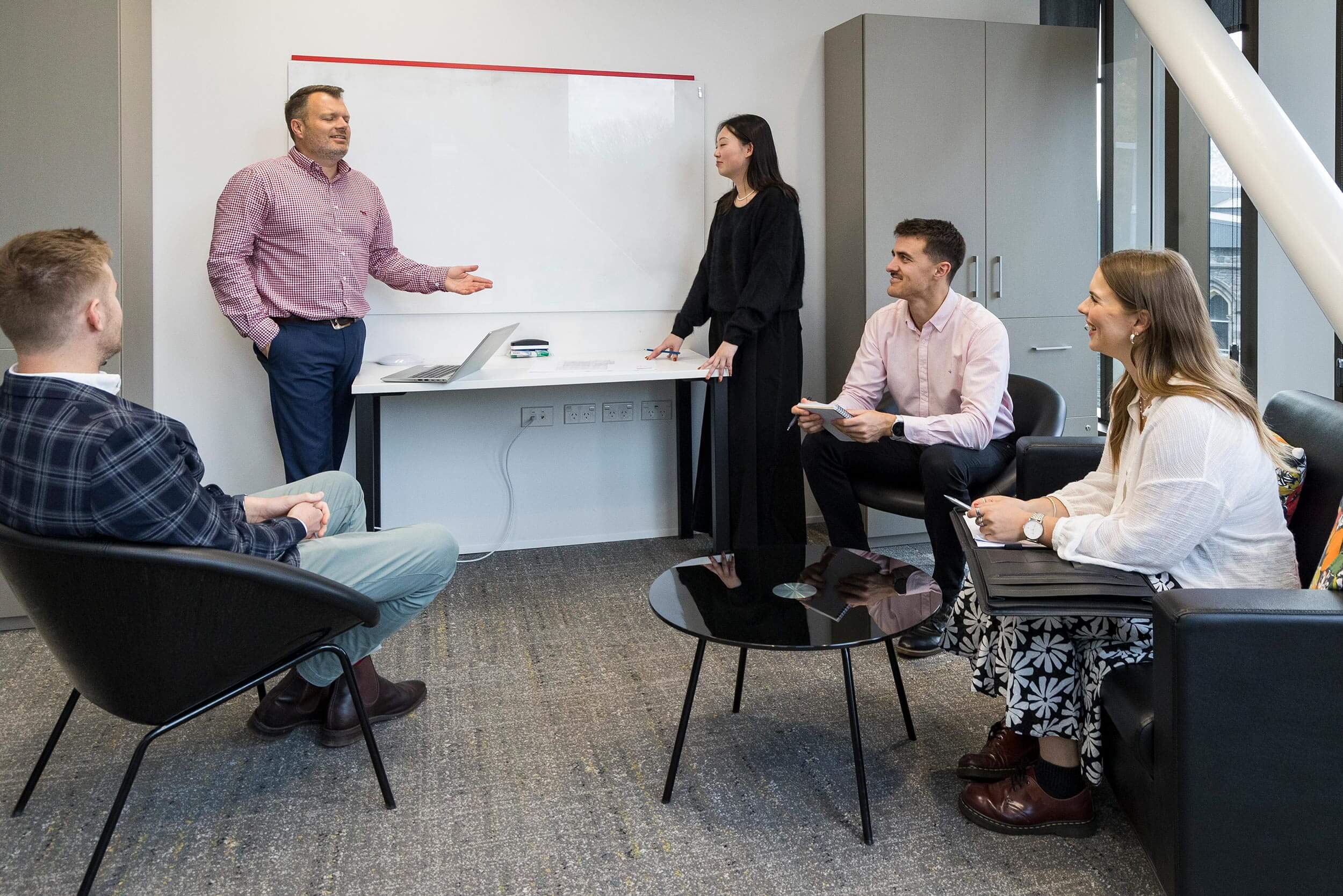 rawlinsons-team Group of staff members in a meeting